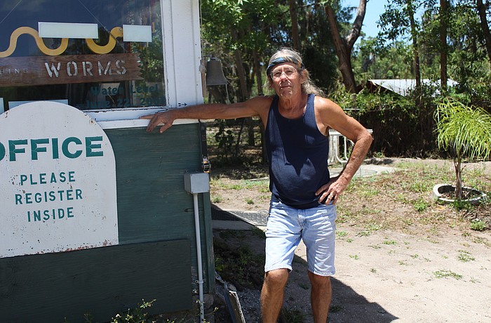 East Countyâ€™s Mark Stukey puts his right hand at the mark showing the high water levels during the 2003 flood.