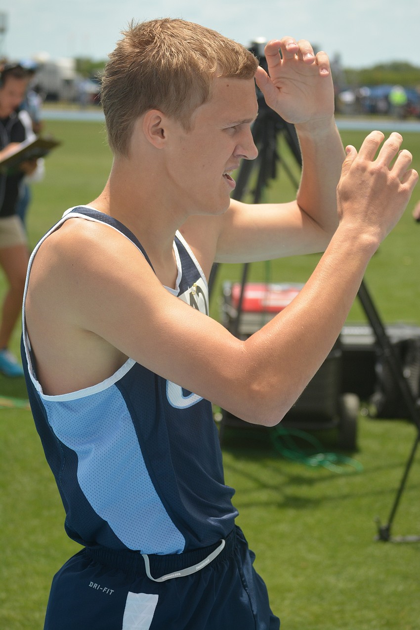 ODA'  s Kai Soderberg raises his hands over his head after finishing 15th in the Class 1 800 meter race.