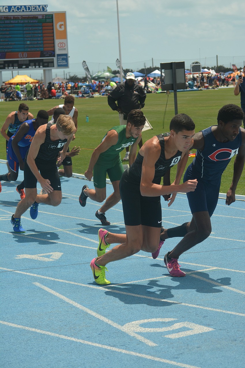 Lakewood Ranch'  s Andrew Dean (17) and John Rivera (9) start the Class 4 800 meter race.