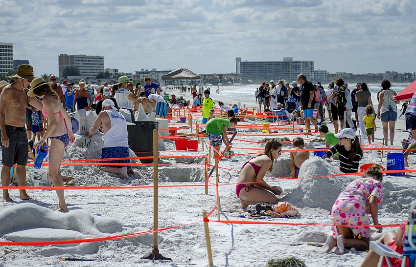 Participants work on their entries  into the 45th annual Amateur Sand Sculpture Contest.