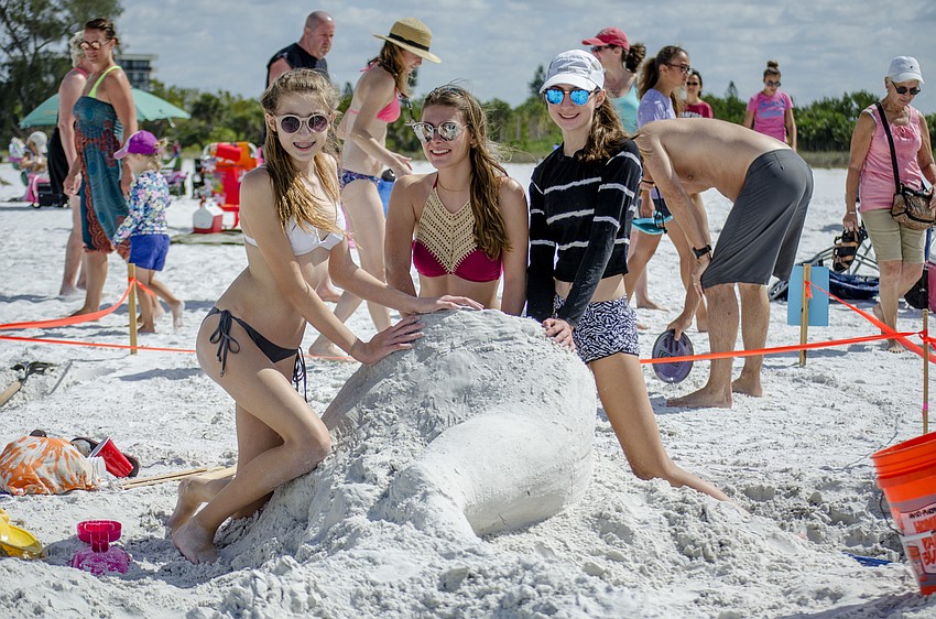 Nicole Colton, Wendy Kiesewetter and Paige Krittenden pose next to their sculpture-in-progress Misty the Mermaid.