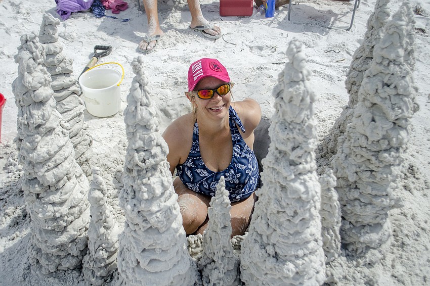 Robin Schmidt works on her teams contribution to the 45th annual Amateur Sand Sculpture Contest called Atlantis.