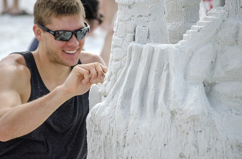 Justin Muklewicz works on his team'    s entry in the 45th annual Amateur Sand Sculpture Contest.