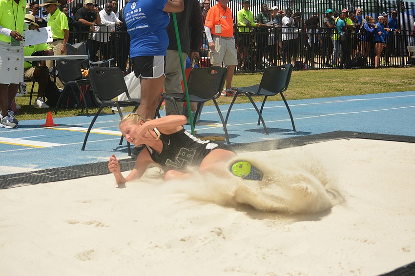 Lakewood Ranch'     s Sophia Falco lands hard in the sand after a triple jump attempt.
