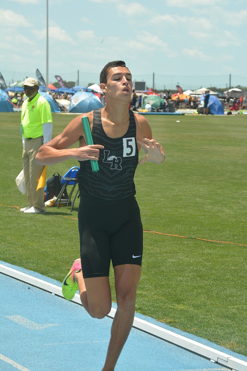 Lakewood Ranch'     s John Rivera crosses the finish line in first place for the boys 4x800 relay team, and lets the world know it.