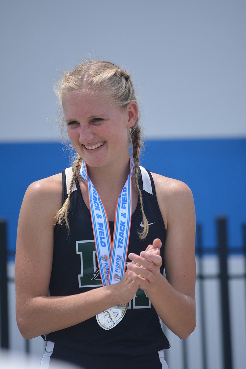 Lakewood Ranch'     s Sophia Falco claps after receiving her second-place medal in the Class 4A girls 100 meter dash.