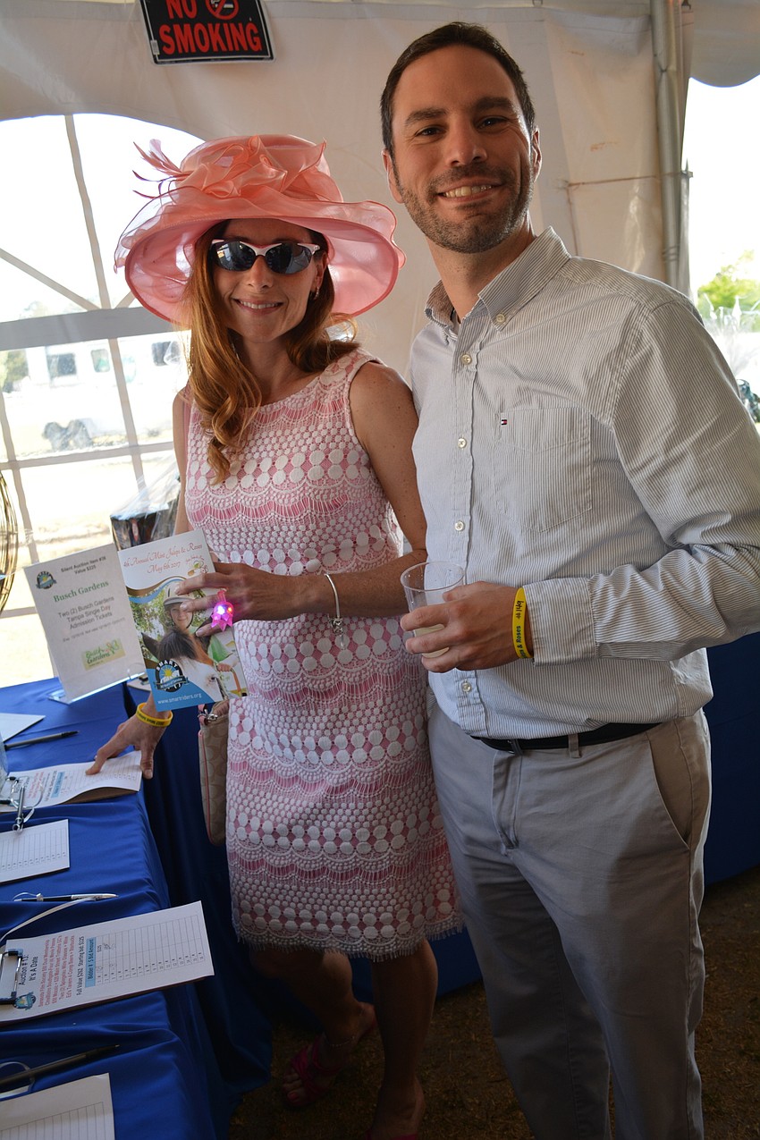 Jennifer Dagnall and Anthony Terzigni check out silent auction items.