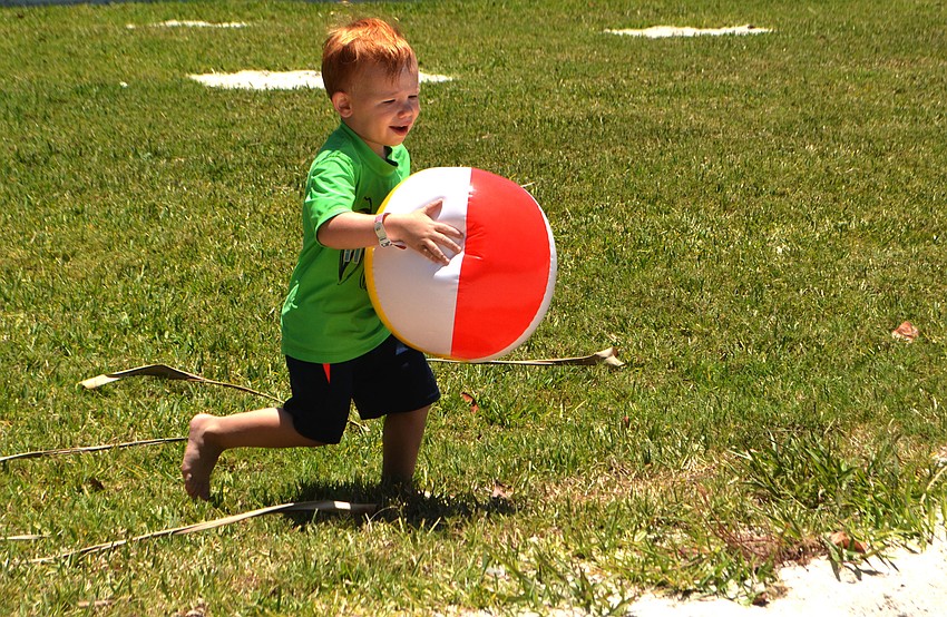 Bryson Heath, 3, plays with a beach ball during the Longboat Key Rotary Club’s first responder event on May 7.
