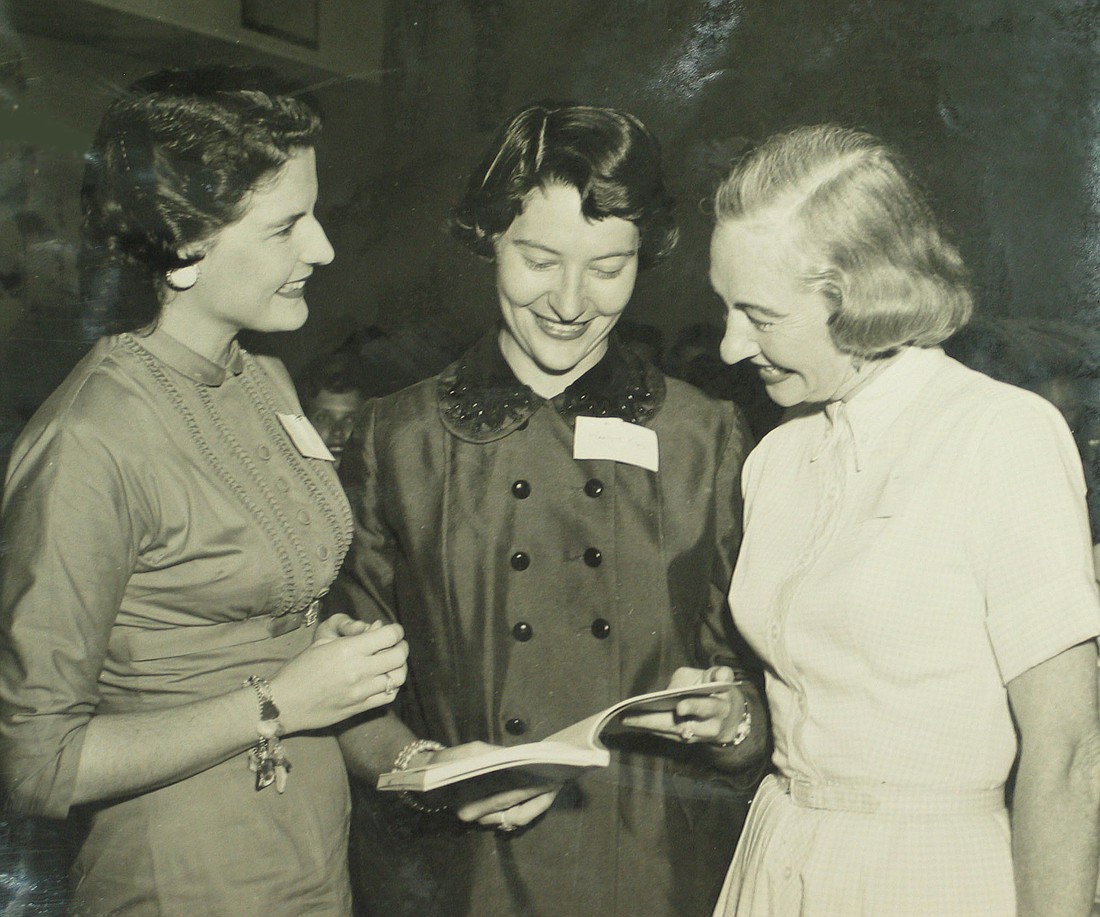 Bitsy Robertson, Marilynn Koach and Scottie Addy confer at an early Junior Welfare League organizational meeting prior to incorporation on March 26, 1957.