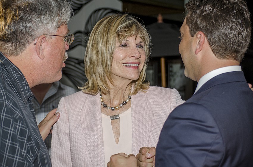Outgoing City Commissioner Suzanne Atwell congratulates incoming City Commissioner Hagen Brody on his win in the Sarasota City Commission race.