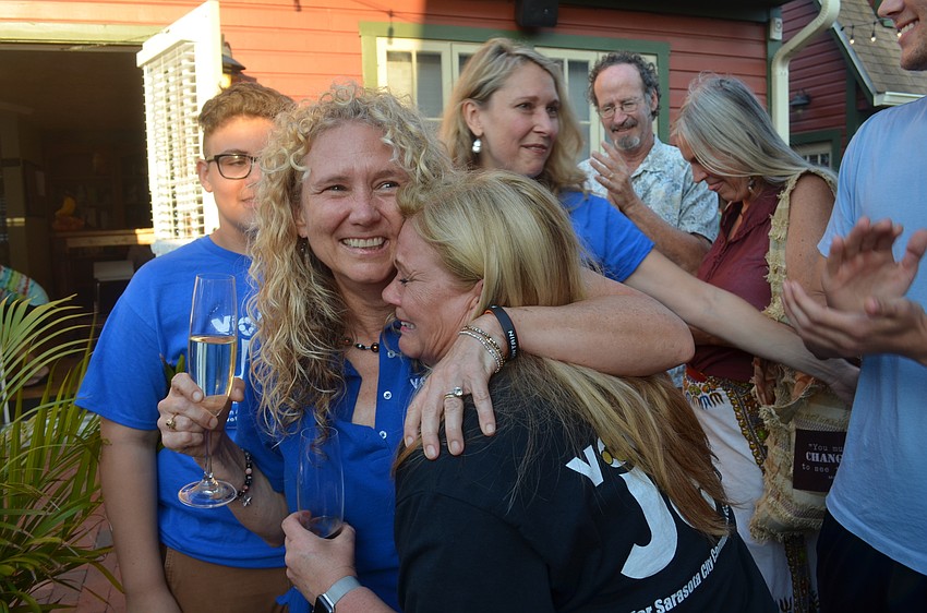 Jen Ahearn-Koch hugs her sister, Betsy Ahearn, after receiving word she won a seat on the Sarasota City Commission.