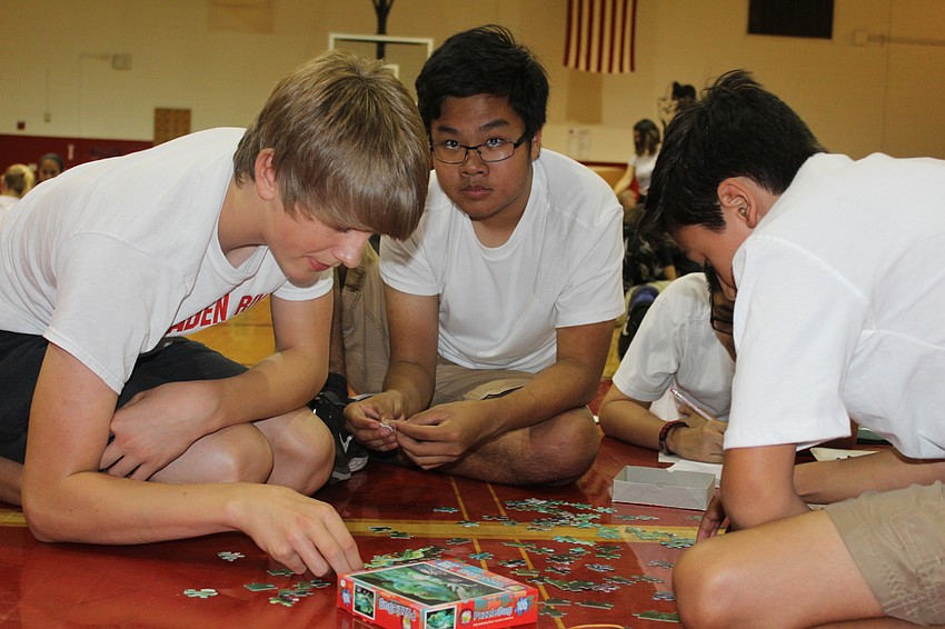 Braden River Middle School eighth graders Thomas Kucharski, Carson Down and Tyler Gonzalez practice team work during STEAM Olympics.