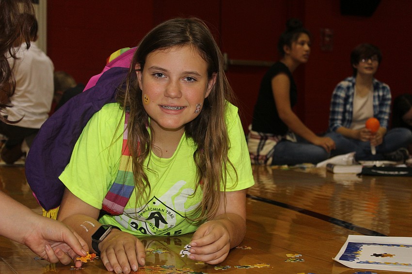 Braden River Middle School seventh grader Heidi Suba works on a jigsaw puzzle.