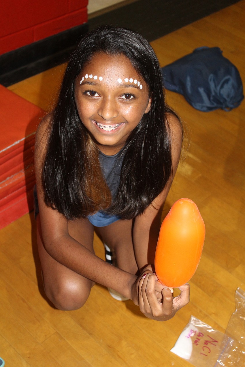 Braden River Middle School sixth grader Farha Matin shows off her blown-up balloon during STEAM Olympics.