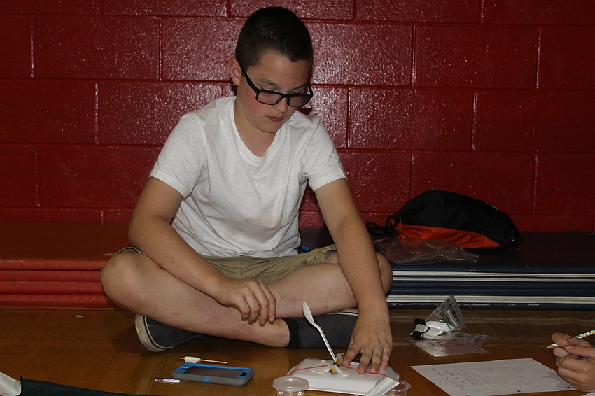 Braden River Middle School seventh grader Conner Kitchner tests his catapult during STEAM Olympics.