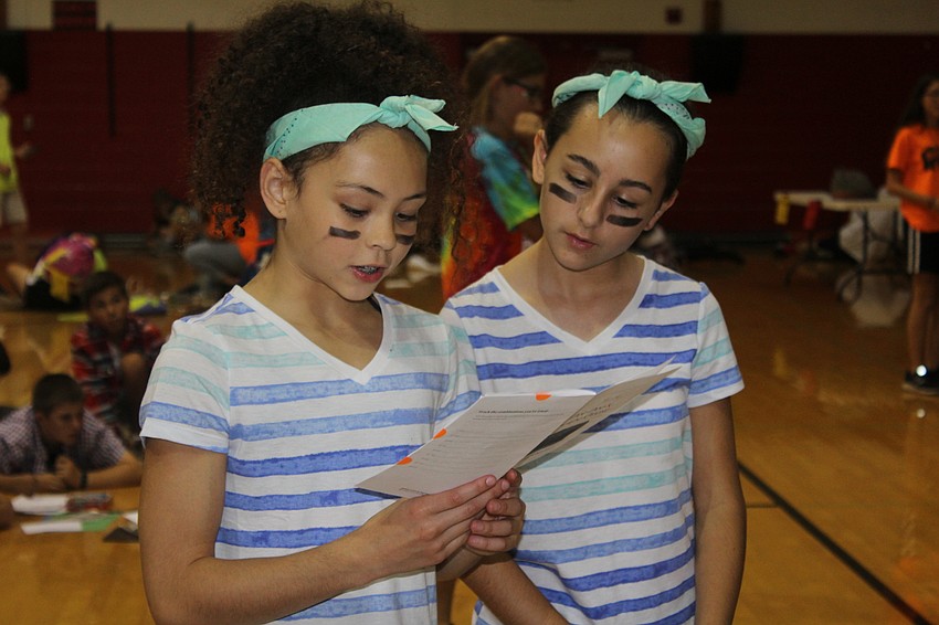Braden River Middle School sixth graders Cilly Lynch and Katia Singh present their conclusions to the judges.
