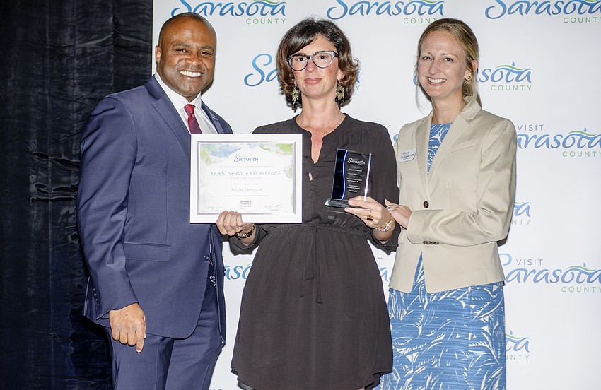 Visit Florida CEO Ken Lawson, winner of the  Guest Service Excellence: Front Line award Nicole Hancock and Visit Sarasota County Vice President Erin Duggan
