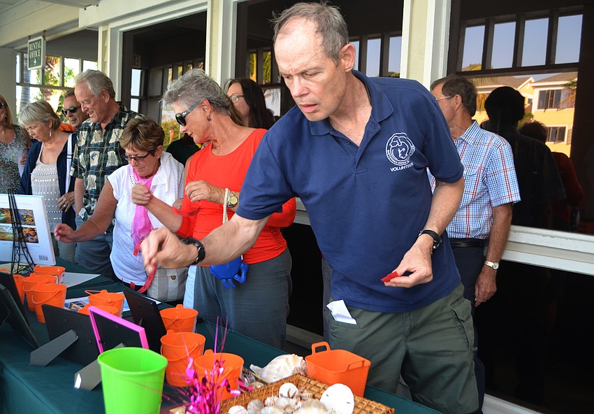Fiesta visitors peruse the raffle tables before enjoying the buffet dinner.