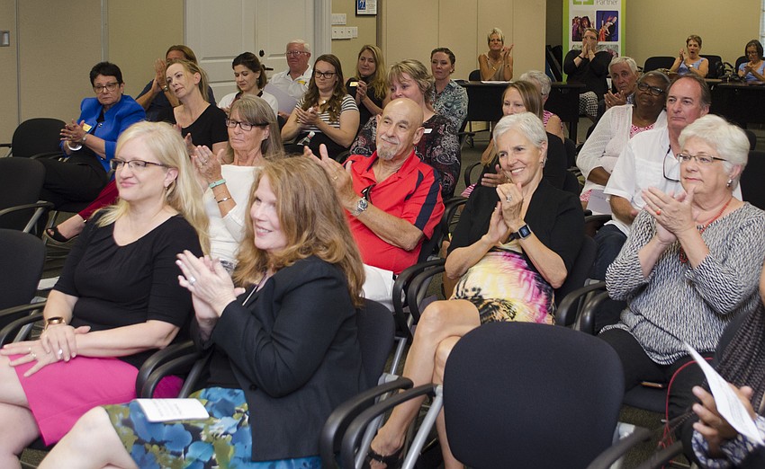 Representatives from several nonprofits clap after listening to Laurel Civic Association representative Sandra Terry’s emotional thank-you address on May 11 at Community Foundation of Sarasota County.