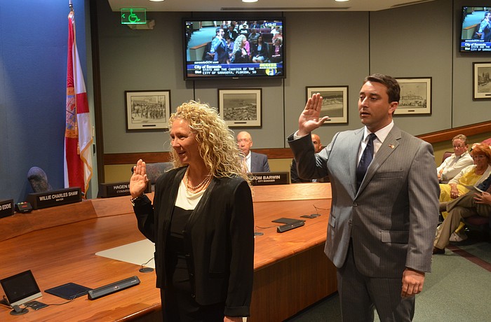 Jen Ahearn-Koch and Hagen Brody are sworn in as city commissioners Friday.