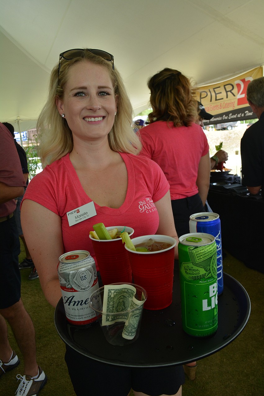Marielle Klein, of Pier 22, serves drinks to guests.