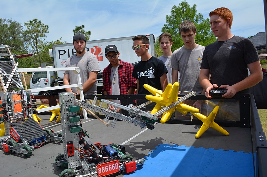 Evan Lynch, right, practices robotics skills.