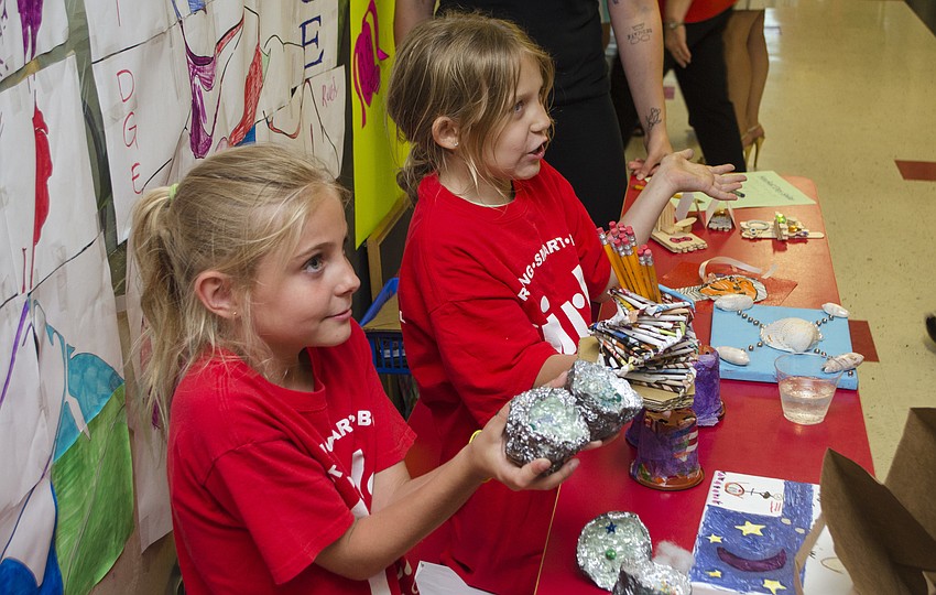 Girls Inc. participants Evie and Rylee sell homemade pencil holders to guests at the Champions for Girls reception on May 11 at Girls Inc. of Sarasota County.
