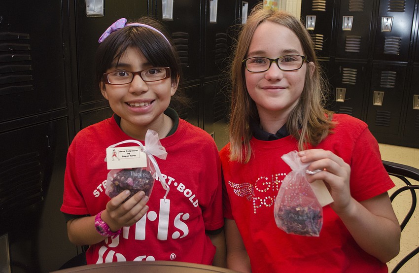 Girls Inc. participants Karen and Julia sell homemade rose potpourri to guests at the Champions for Girls reception on May 11 at Girls Inc. of Sarasota County.