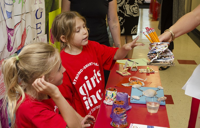Girls Inc. participants Evie and Rylee sell homemade pencil holders to guests at the Champions for Girls reception on May 11 at Girls Inc. of Sarasota County.