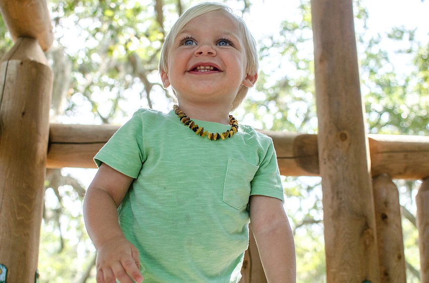 Adam Ulrich plays on the playground during St. Boniface Preschool'    s end of year celebration.