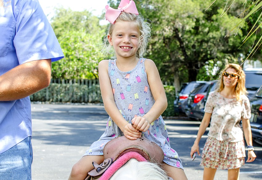 Caroline Wallin rides a pony during St. Boniface Preschool'    s end of year celebration.