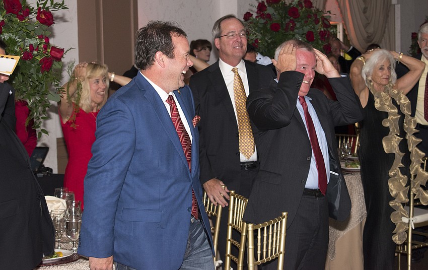 Guests laugh while playing heads or tails at Golden Hearts: A Celebration of Philanthropy on May 13 at Michael’s On East.