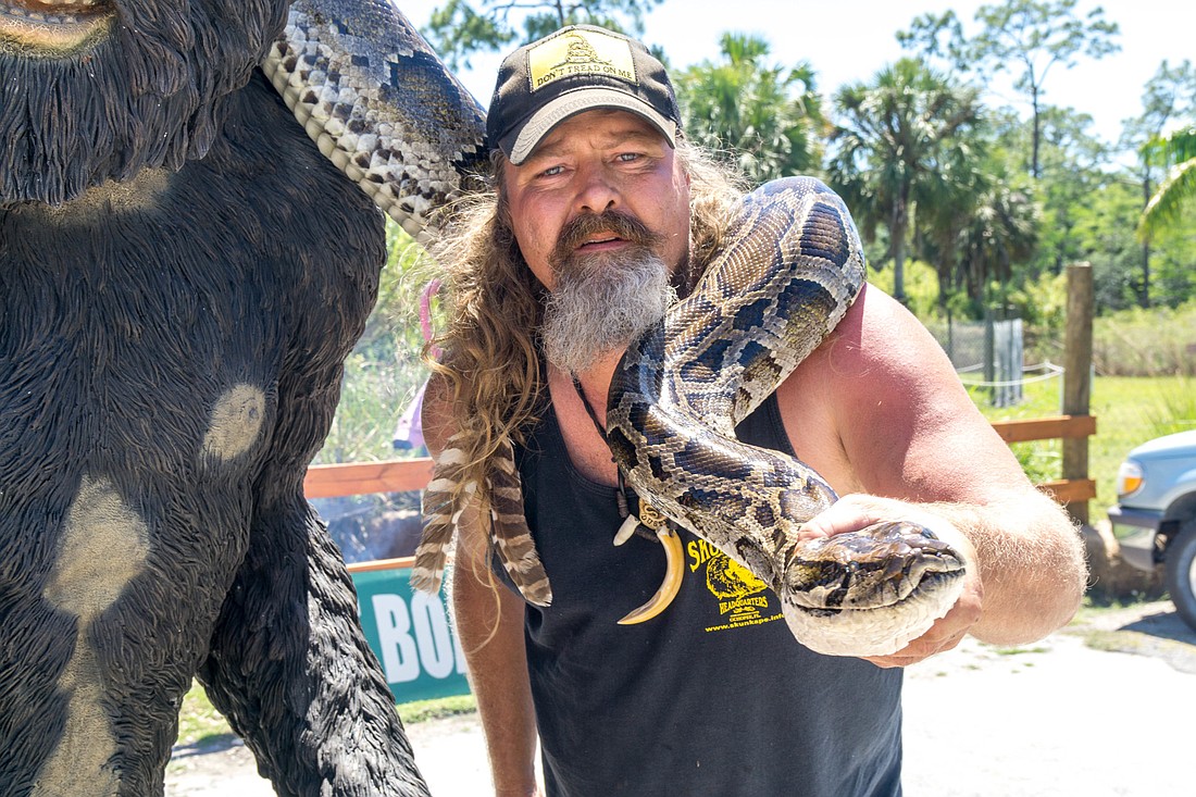 Dusty Crumm captures a 16-foot 10-inch python in the Everglades. It contained 78 eggs. Photo courtesy of Joey Waves, of Island Media Group.
