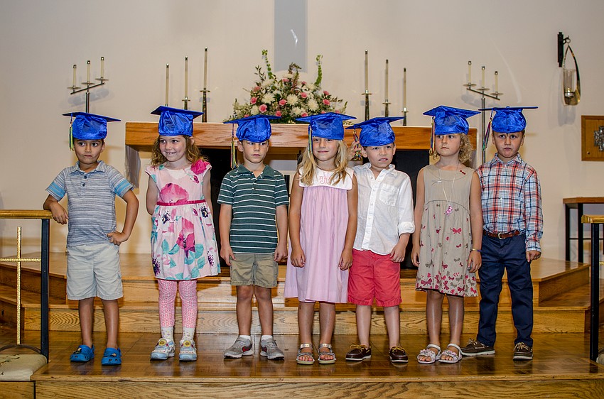 The seven graduates of St. Boniface Preschool line up on the stage at the beginning of the program.