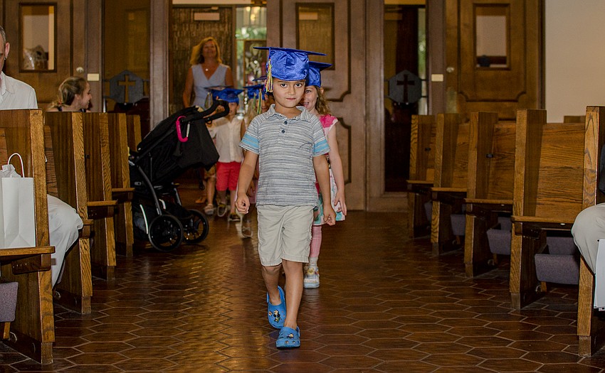 David Cook leads the class down the aisle during the St. Boniface Preschool graduation.