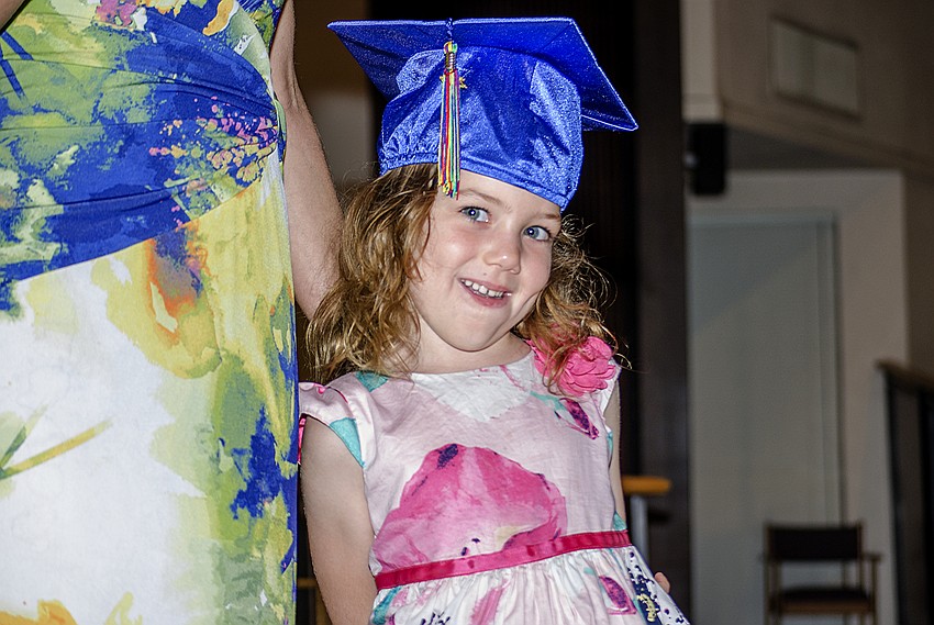 Fiona Quinto smiles as St. Boniface Preschool Director Sarah Schebel introduces Quinto during the St. Boniface Preschool graduation ceremony.