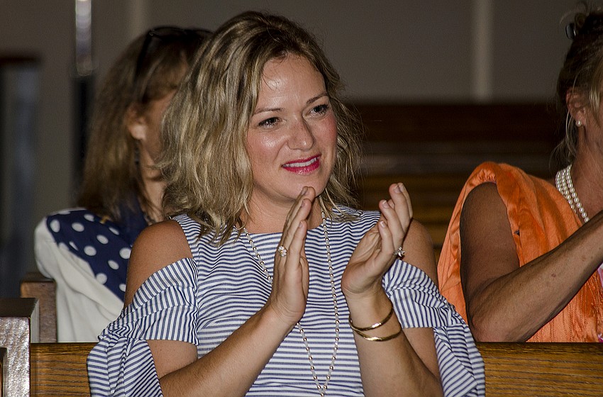 Shannon Wallin applauds after graduates performed.