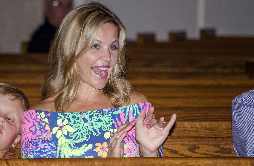 Beth Bobb waves to her son during the St. Boniface Preschool graduation ceremony.