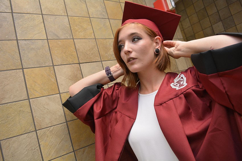 Braden River'     s Olivia Burnett, 18, adjusts her cap before the ceremony begins.