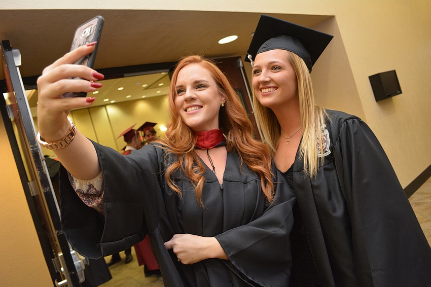 Teacher and cheerleading coach Lauren Raab snaps a selfie with student and cheerleader Kennedy Hunter before Braden River'     s ceremony.
