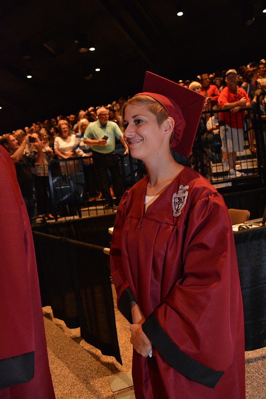 Braden River'     s Shae-Lynn Gillam grins after spotting her family in the crowd as she enters the auditorium.