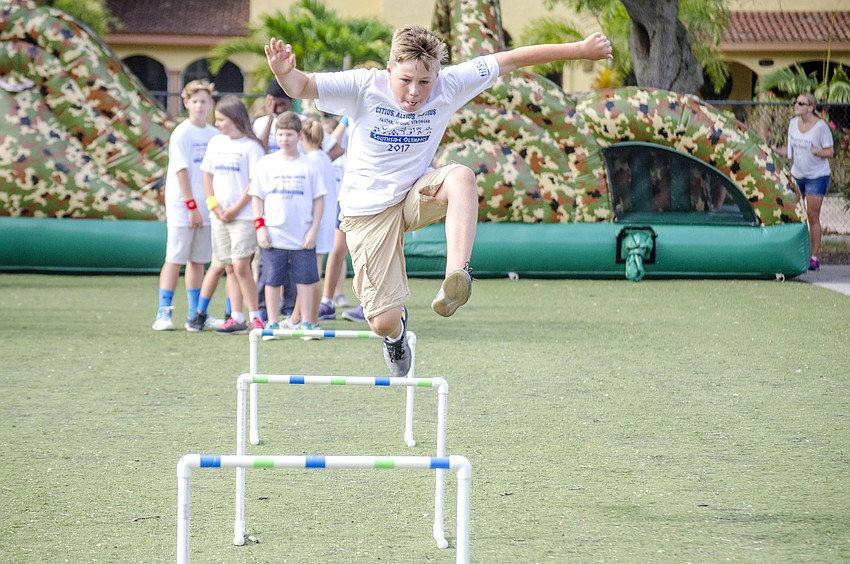 Tristan Asfur jumps over hurdles during Southside'      s Celebrate Learning Day.