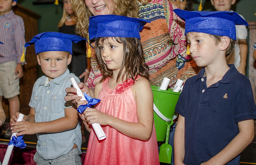 Delaney Fish receives her diploma during the First Presbyterian Preschool graduation ceremony.