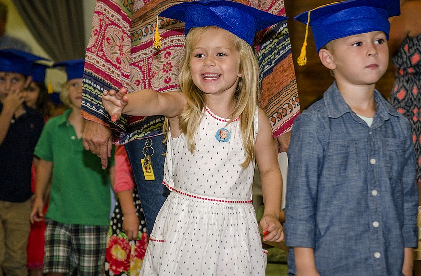 Lucy Mangum waves to her mother as she makes her way to the stage.