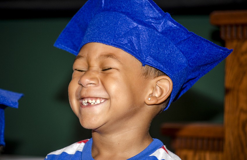 Tyus Hameed smiles after finishing a song during the First Presbyterian Preschool graduation ceremony.