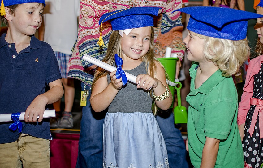 Harper Gratton smiles after receiving her diploma during the First Presbyterian Preschool graduation ceremony.