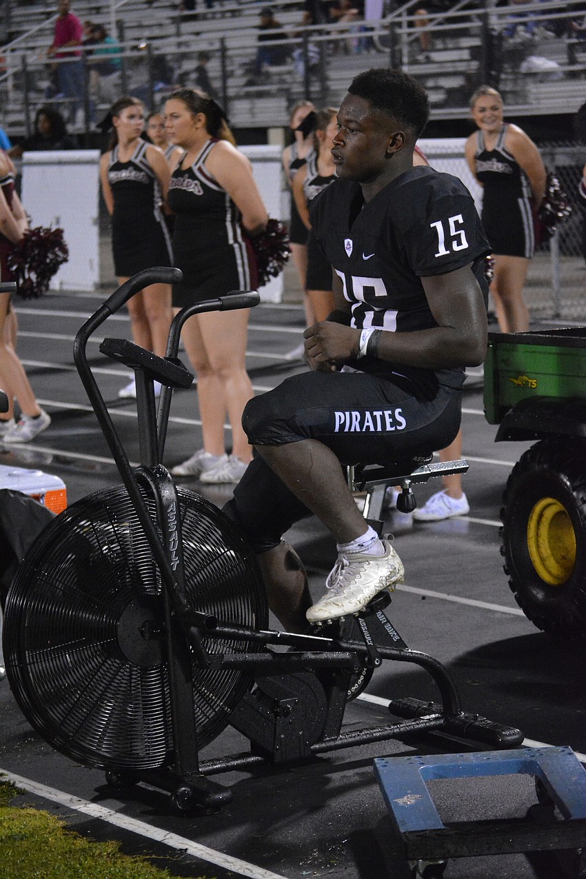 Knowledge McDaniel rides the exercise bike.