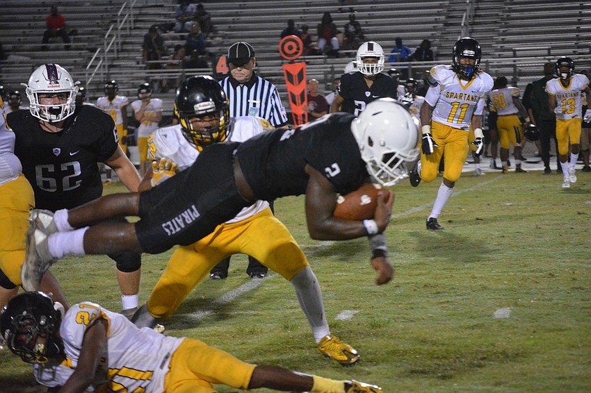 Deshaun Fenwick leaps over a defender for a first down.