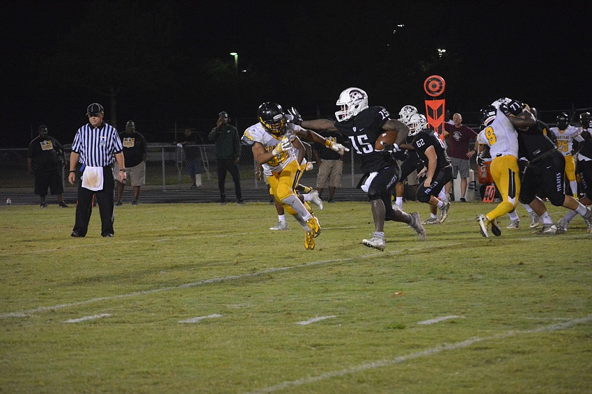 Knowledge McDaniel stiff-arms a defender.