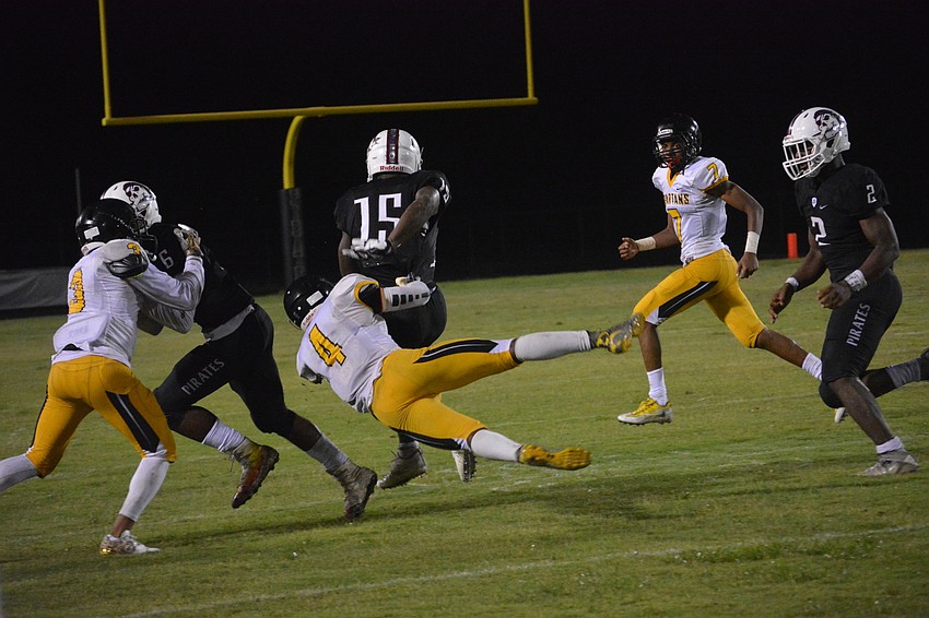 Knowledge McDaniel throws a defender to the ground.